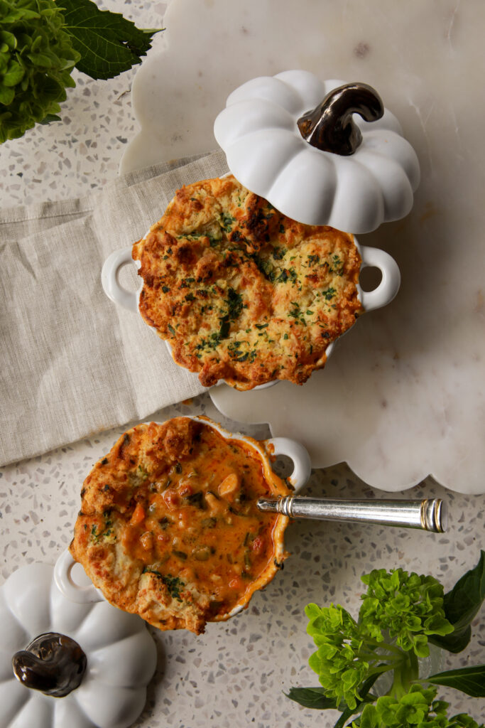 Creamy Marry Me Chicken Pot Pie Soup topped with golden cheddar bay biscuits in white ramekins