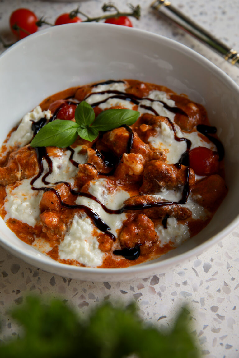 Creamy burrata gnocchi with Italian sausage, cherry tomatoes, fresh basil, and balsamic glaze.