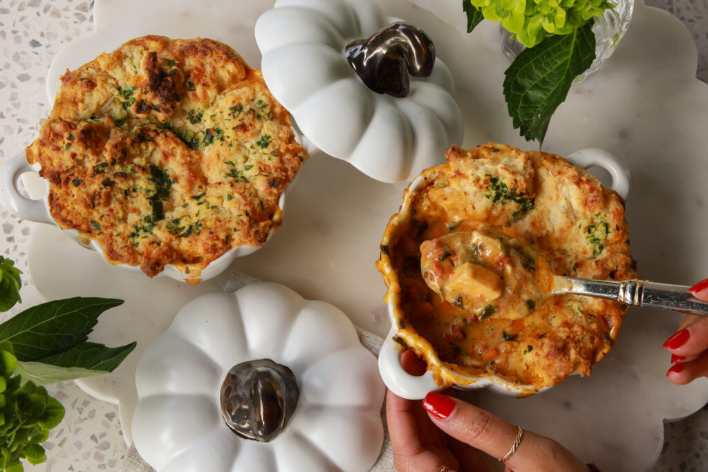 Creamy Marry Me Chicken Pot Pie Soup in white ramekins topped with golden cheddar bay biscuits
