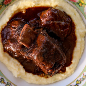 red wine short braised ribs over creamy mashed potatoes in a bowl