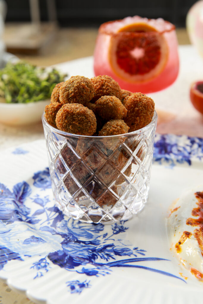 Crispy feta stuffed fried olives served with garlicky yogurt and paprika butter