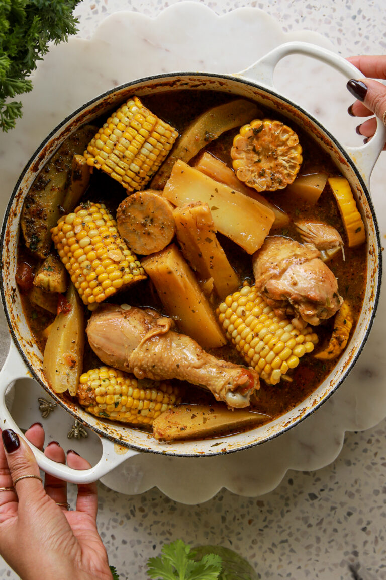 Panamanian caldo de pollo served in a bowl with bone-in chicken, yuca, corn, green plantain, and fresh cilantro