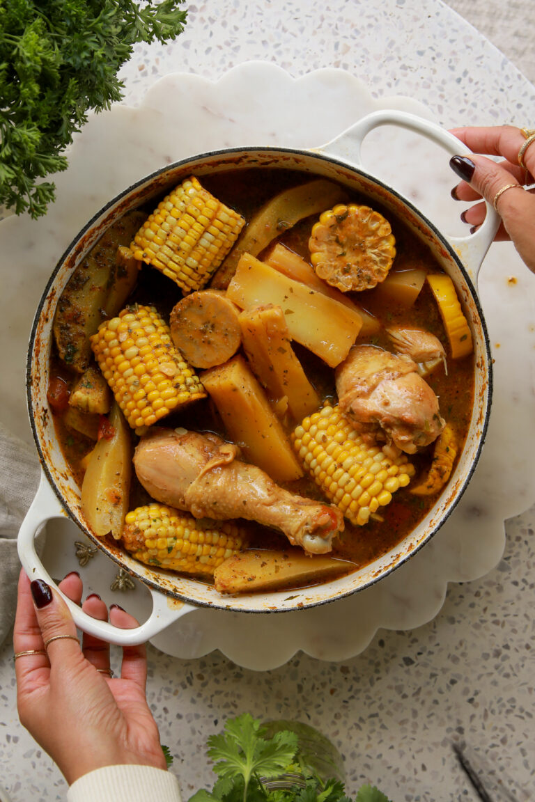 Panamanian caldo de pollo served in a bowl with bone-in chicken, yuca, corn, green plantain, and fresh cilantro