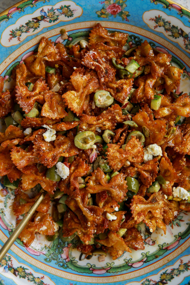 Hot honey crispy pasta salad with feta, olives, pistachios, and sun-dried tomato dressing