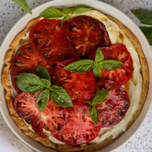 Fresh heirloom tomato tart with whipped Brie on a flaky pie crust